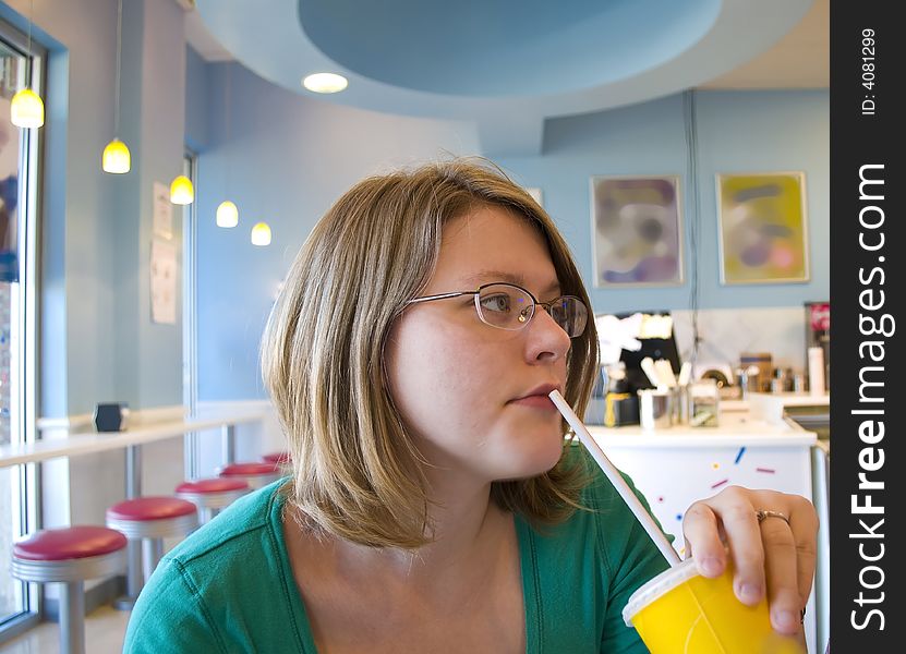 Picture of a woman drinking from a straw. Picture of a woman drinking from a straw