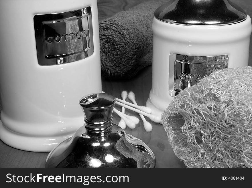 This is a black and white image of various hygeine and cosmetic items for the bathroom.