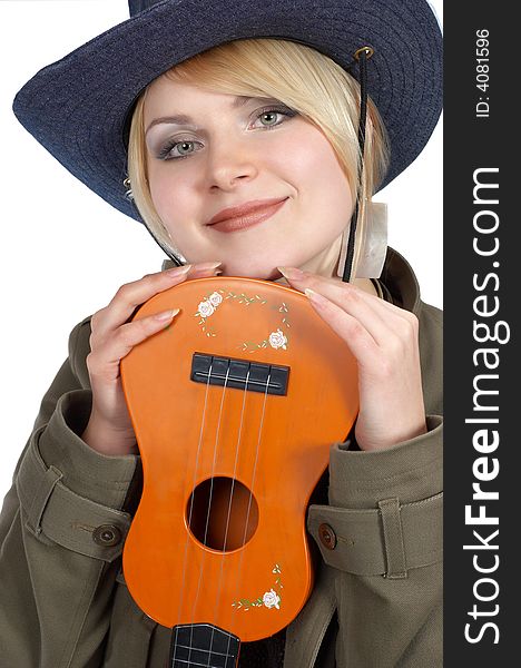 Cute blond cowgirl holding small orange guitar. Cute blond cowgirl holding small orange guitar