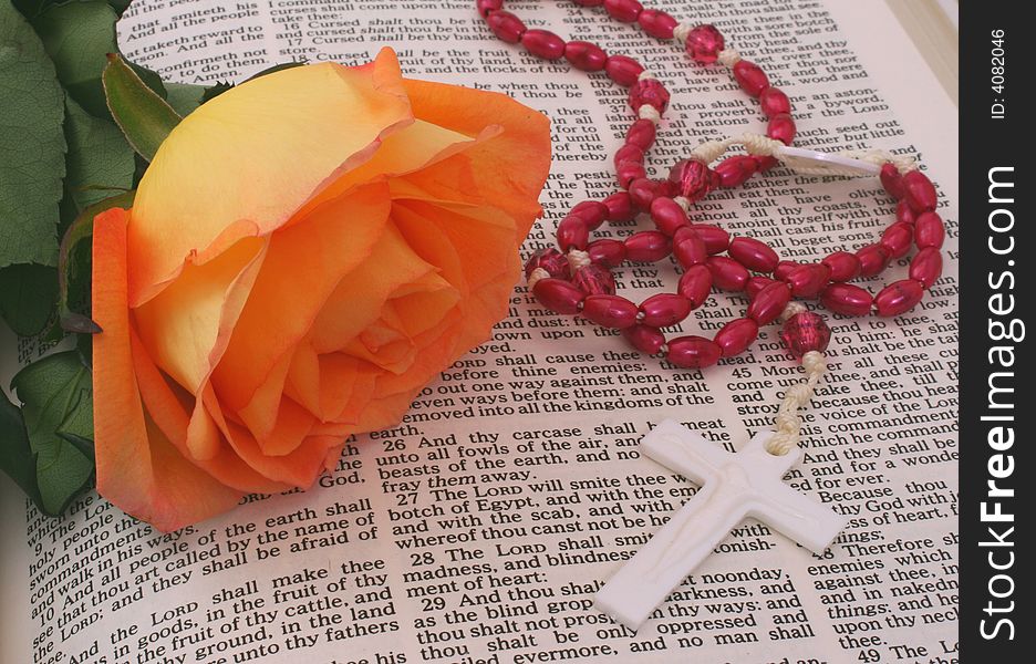 Rose With Rosary on open Bible. Rose With Rosary on open Bible