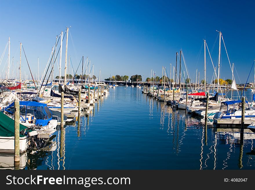 Water alley between two rows of moored boats in marina. Water alley between two rows of moored boats in marina