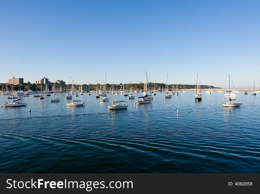 Bay with moored sail boats, blue water and azure sky. Bay with moored sail boats, blue water and azure sky