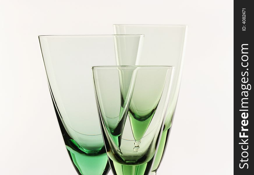 A glass beside a stack of white plates - on white background. A glass beside a stack of white plates - on white background