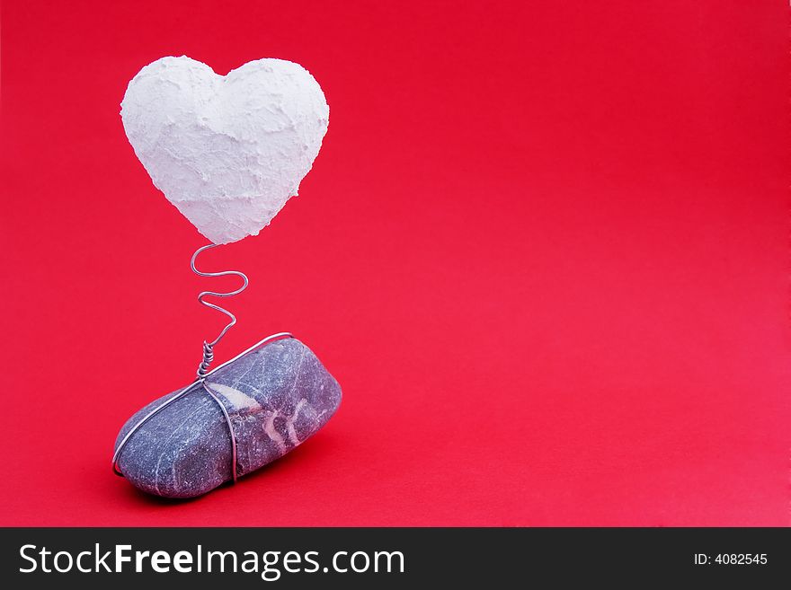 A white heart on a stone base