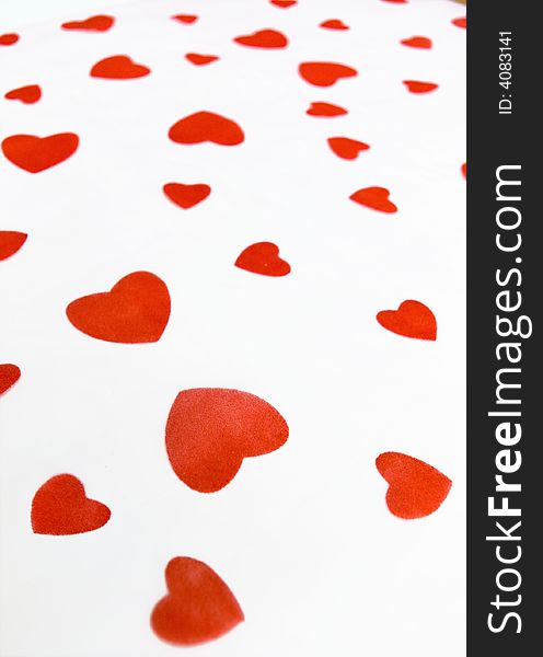 Background made from a white cloth with velvet red hearts. Background made from a white cloth with velvet red hearts