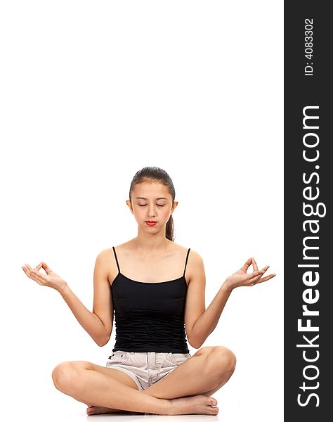 Girl meditating - sitting on a white surface