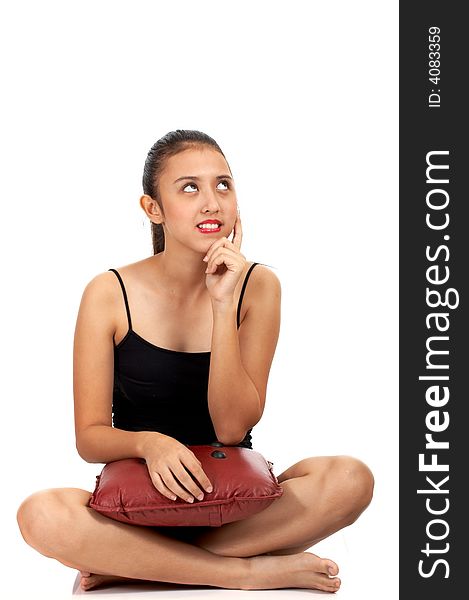 Girl sitting down and looking up in thoughtful expression. Girl sitting down and looking up in thoughtful expression