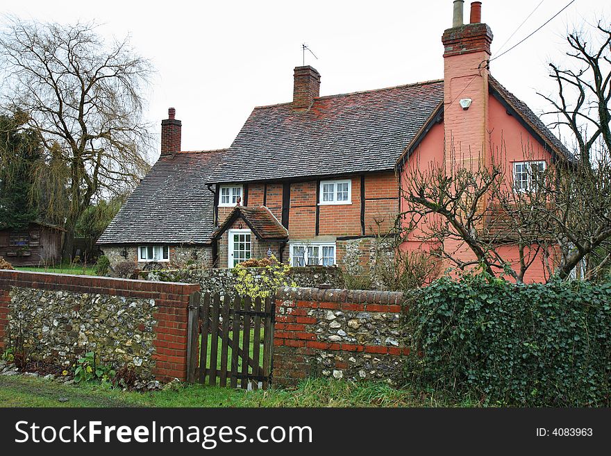 Traditional Timber Framed English Vllage Cottage with a Brick and Flint Wall to the front. Traditional Timber Framed English Vllage Cottage with a Brick and Flint Wall to the front