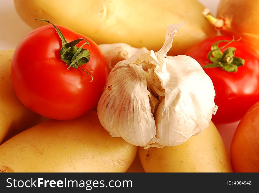 Close up of garlic, tomato, potatoes and onion. Close up of garlic, tomato, potatoes and onion