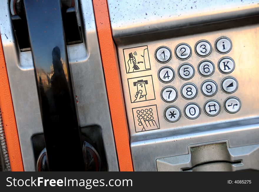 A view with a public phone close up