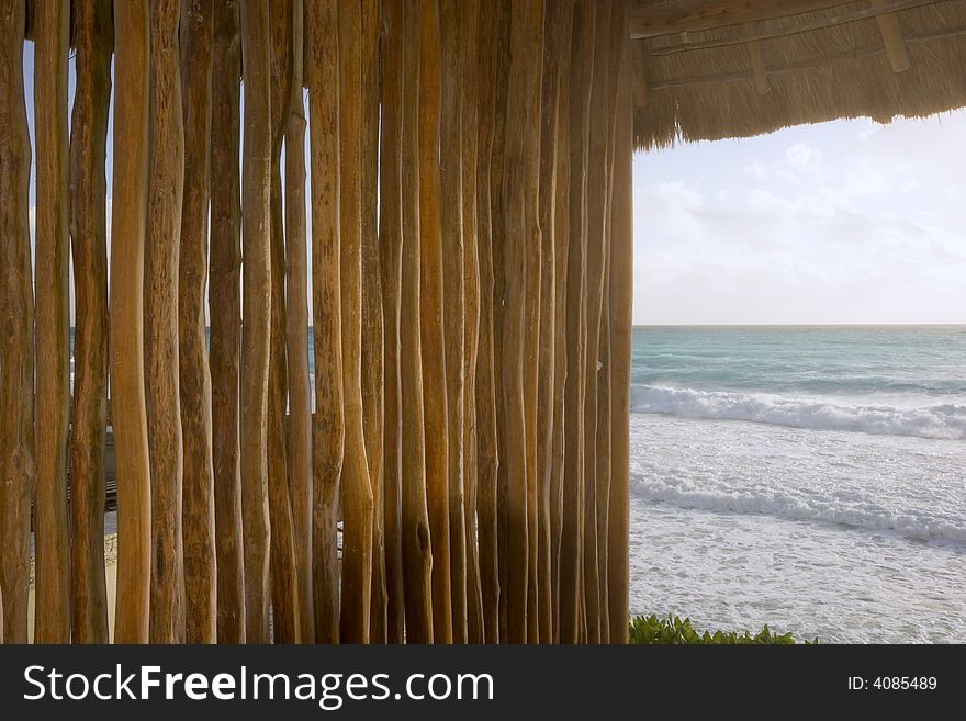 A natural wood and straw shelter on the beach. A natural wood and straw shelter on the beach