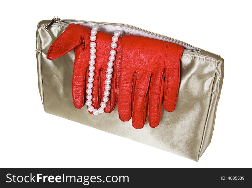 Female bag with gloves and costume jewellery on a white background