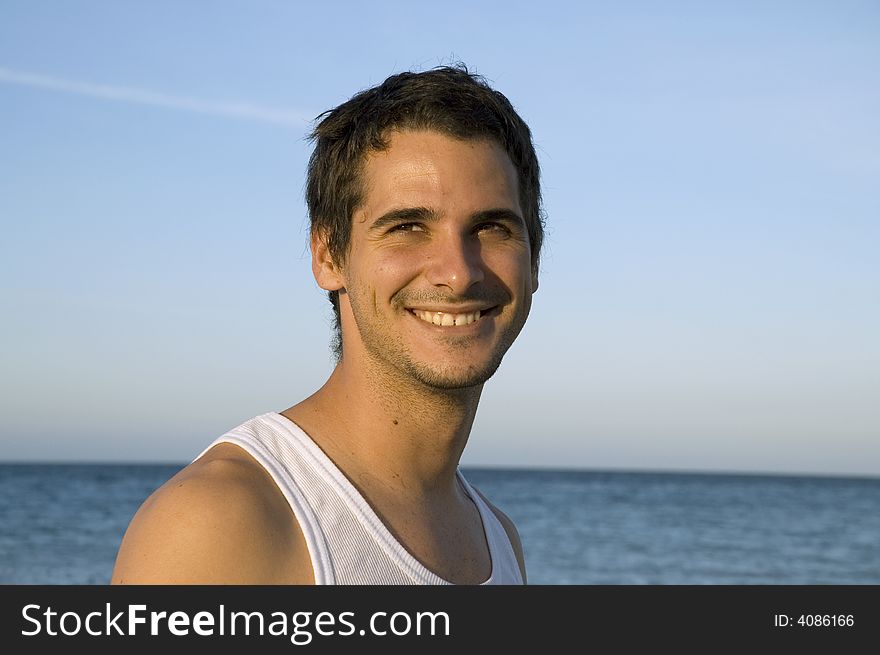 Young happy male on tropical beach background. Young happy male on tropical beach background