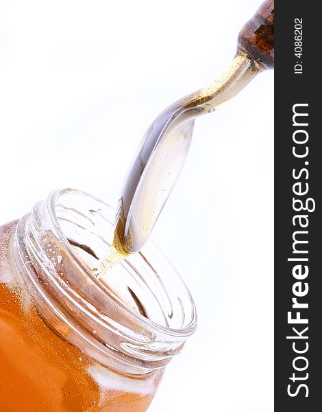 Close up of honey jar on white background with clipping path