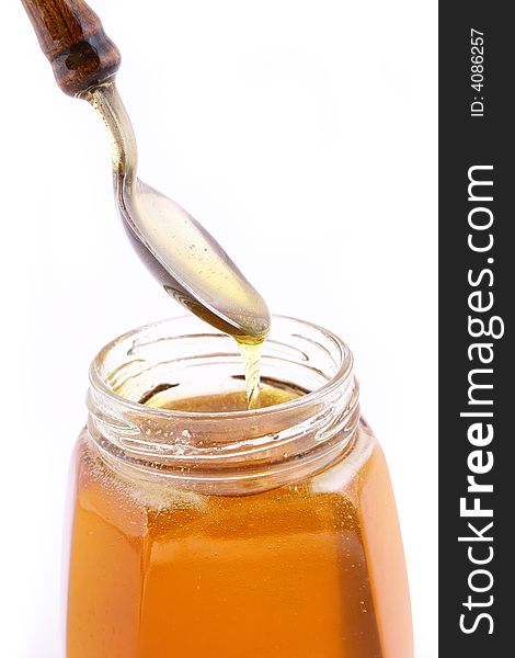 Close up of honey jar on white background with clipping path