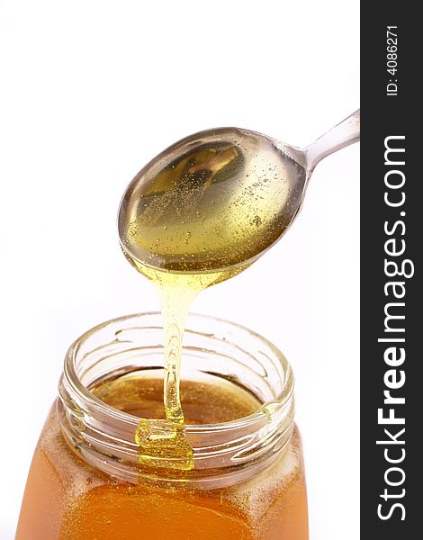 Close up of honey jar on white background with clipping path