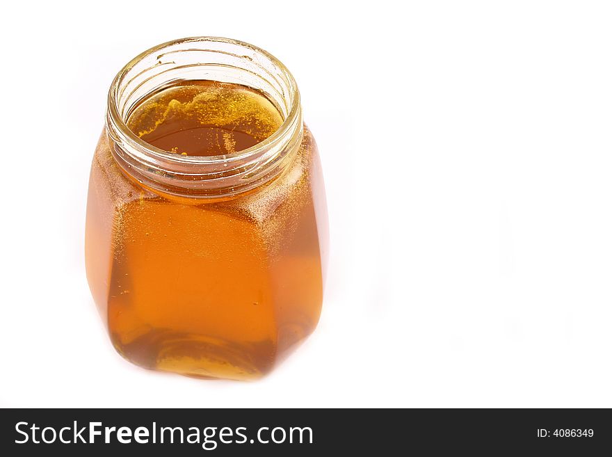 Close up of honey jar on white background with clipping path