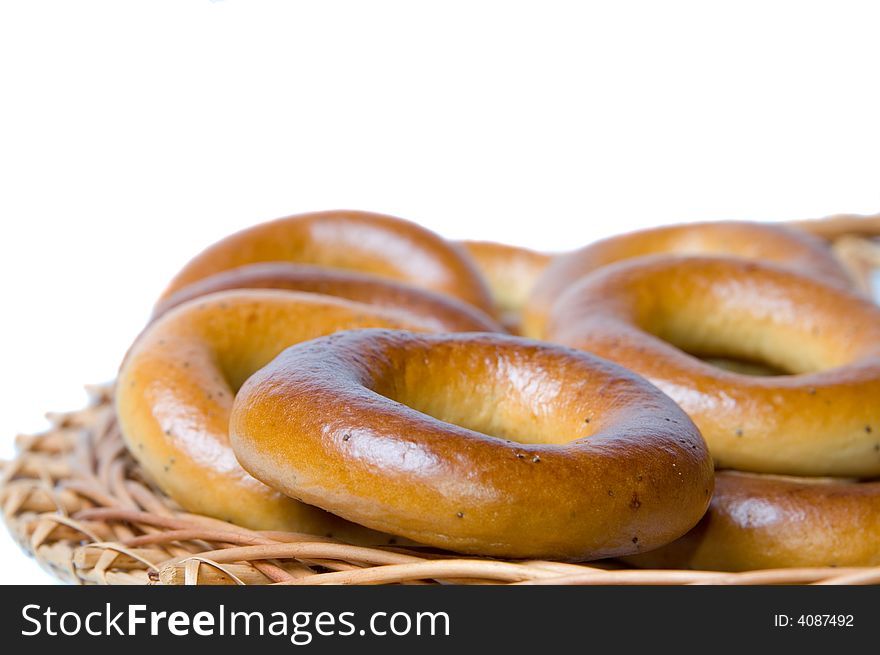 Appetizing bagels on wicker plate at the table