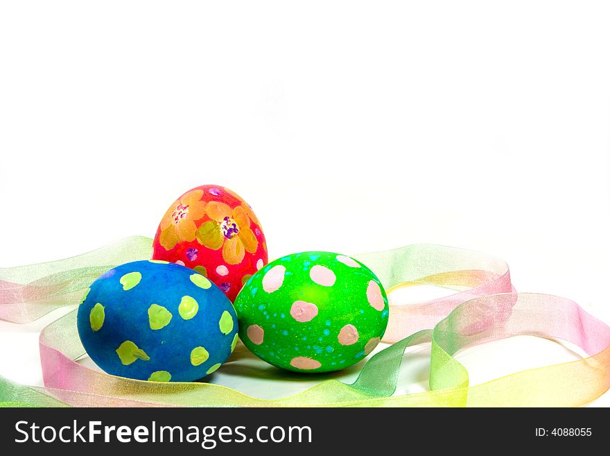 Three handpainted Easter eggs with ribbon on a white background. Three handpainted Easter eggs with ribbon on a white background.