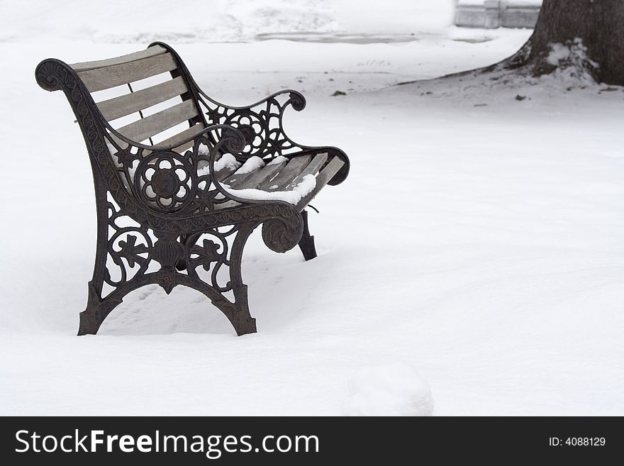 Wrought iron bench in the snow