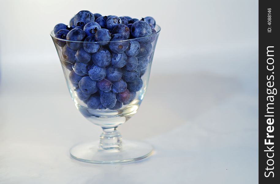 Fresh blueberries in crystal glass.