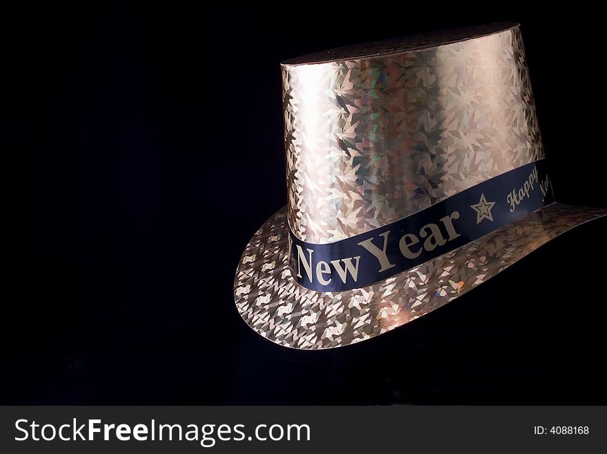 A New Year's Eve party hat taken on a black background.