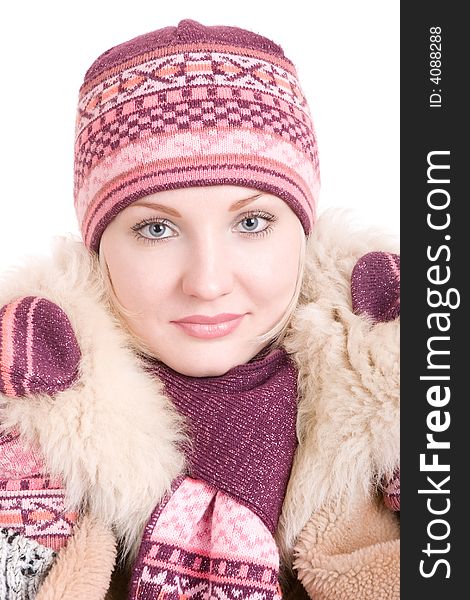 A smiling girl dressed in winter cap, coat, mittens and scarf looks up. A smiling girl dressed in winter cap, coat, mittens and scarf looks up