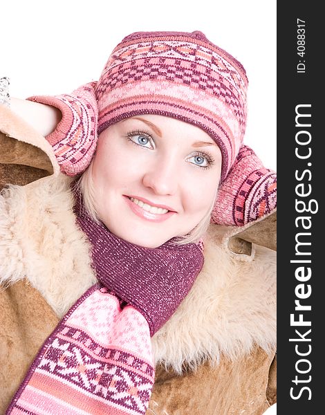 A smiling girl dressed in winter cap, coat, mittens and scarf looks up. A smiling girl dressed in winter cap, coat, mittens and scarf looks up