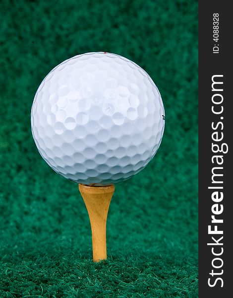 White Golf Ball On Natural Wood Tee