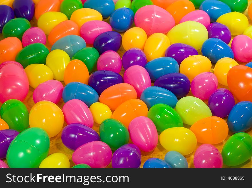 A background of multicolored plastic Easter eggs. A background of multicolored plastic Easter eggs.