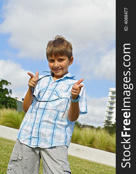 Kid pointing fingers at photographer