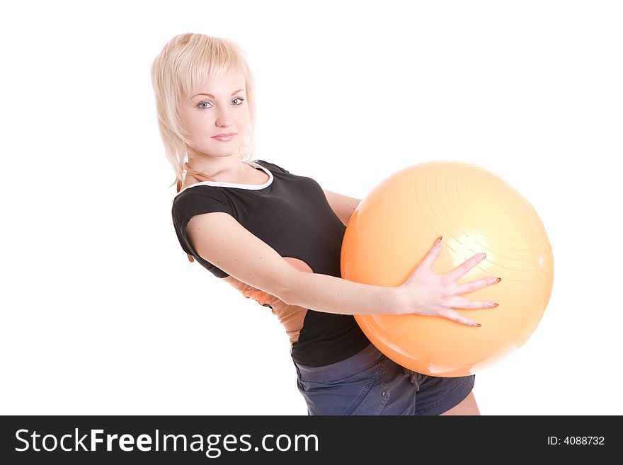 Young woman with a big yellow ball in her hands goes in for fitness. Young woman with a big yellow ball in her hands goes in for fitness