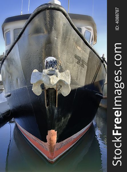 Bow of a ship docked in the harbor.