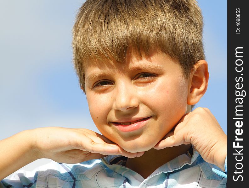 Boy with hands under his chin. Boy with hands under his chin