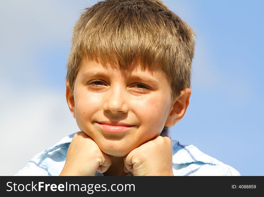 Boy with hands under his chin. Boy with hands under his chin