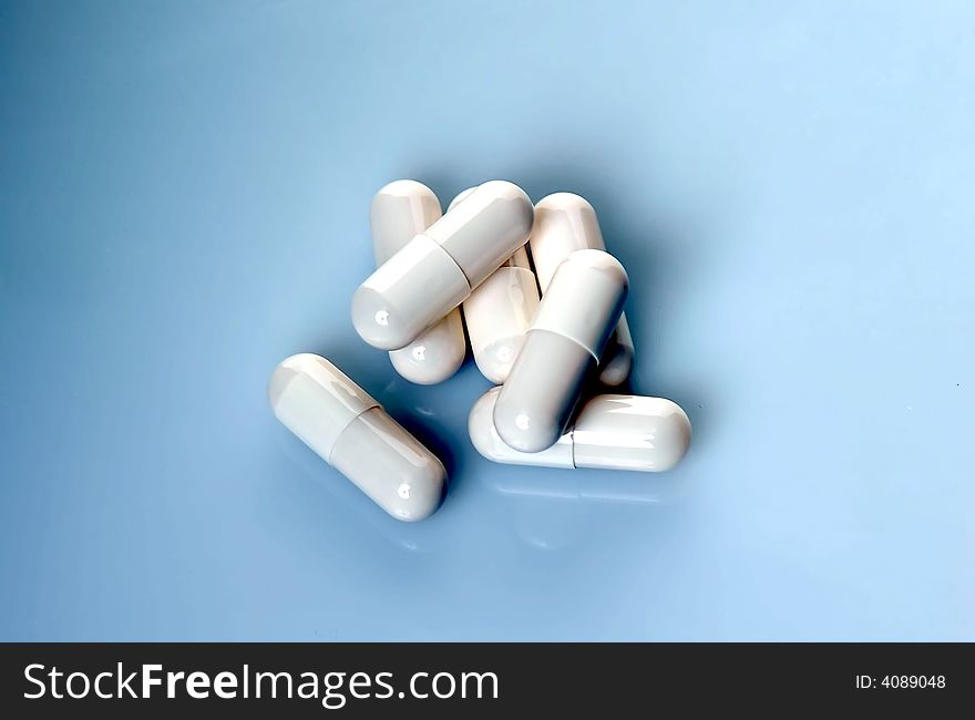 Bunch of pills on blue gradient background