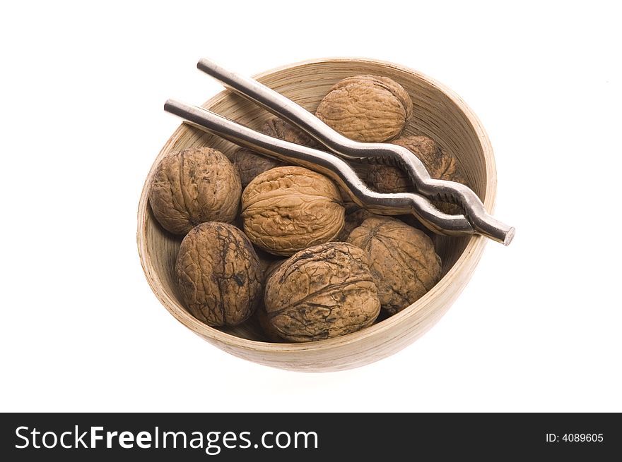 Walnuts and nutcracker isolated on the white background