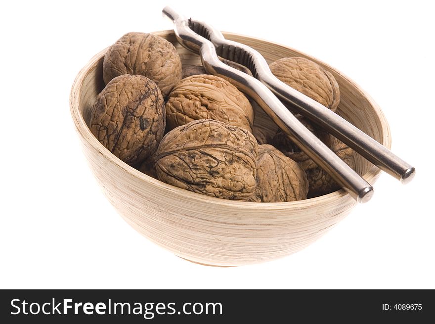 Walnuts and nutcracker isolated on the white background