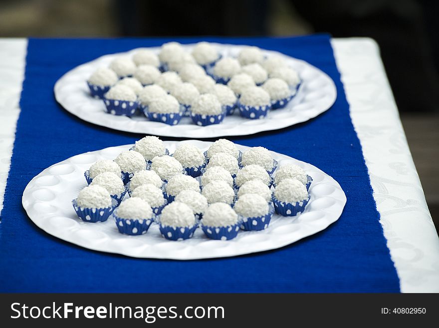 Wedding candies wrapped in blue on a plate