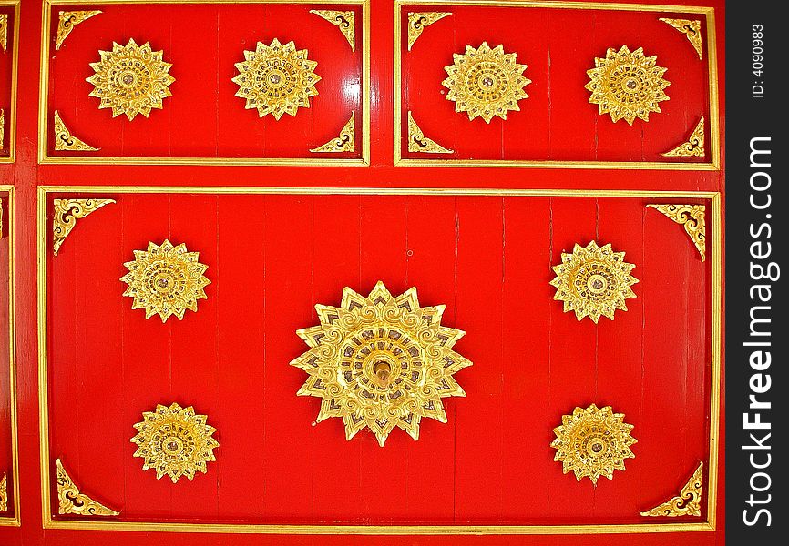 Red wooden background ornately decorated with gold trim. Red wooden background ornately decorated with gold trim