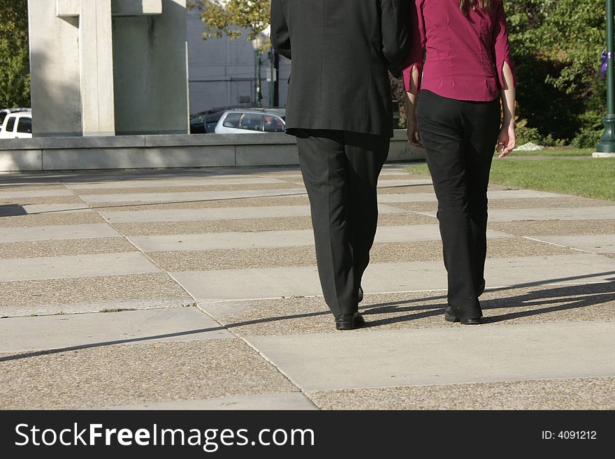 Rear view of businessman and businesswoman walking together towards building. Rear view of businessman and businesswoman walking together towards building