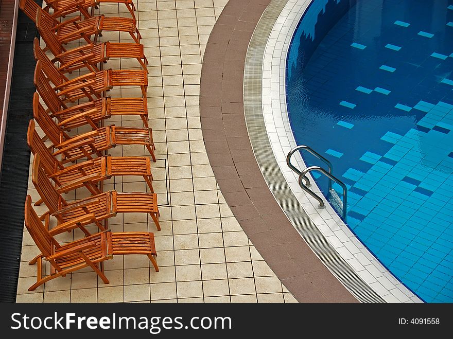 Chair and swimming pool inside the hotel