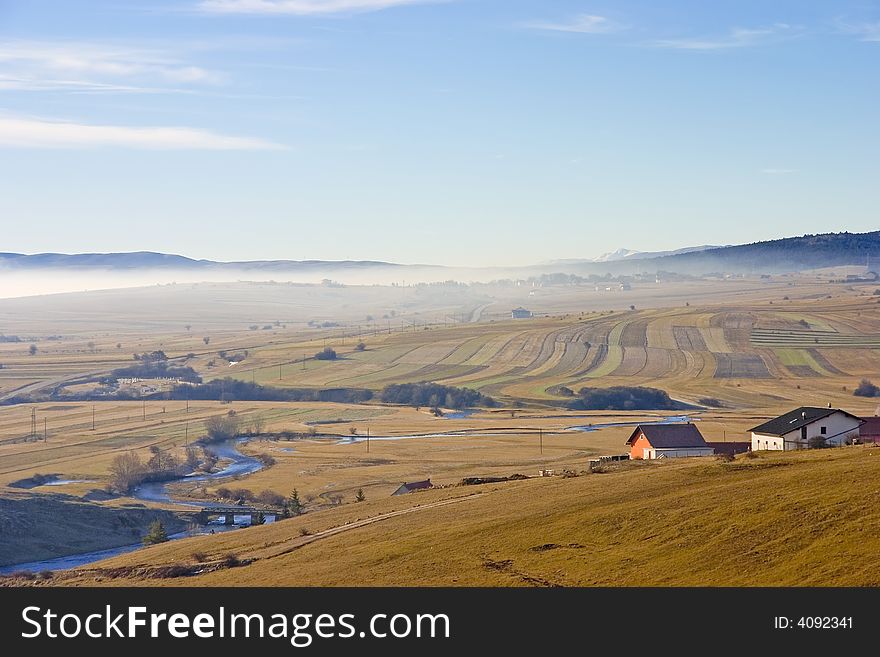 Landscape and river - green fields, the blue sky