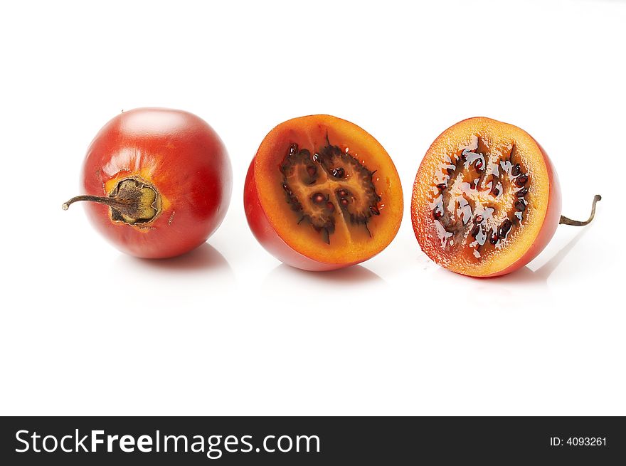 Tamarillos (Cyphomandra betacea) cut in two parts, seeds and fruit