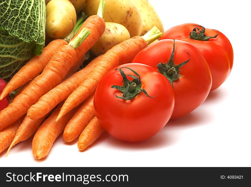 Three tomatoes and vegetables on white background