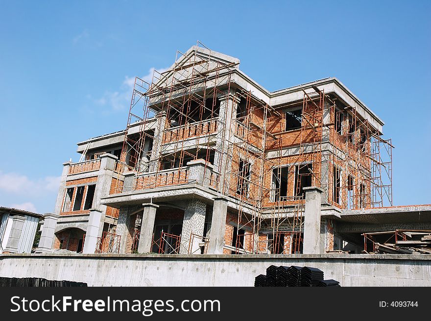 Construction of a new bungalow house site with scaffolding. Construction of a new bungalow house site with scaffolding