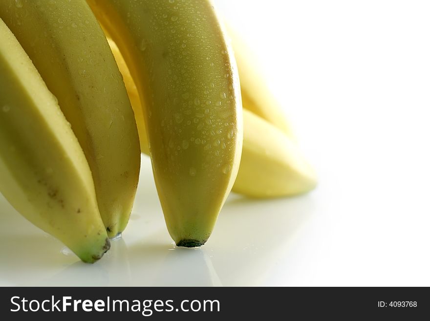 Image from fruits series: wet bananas on bright