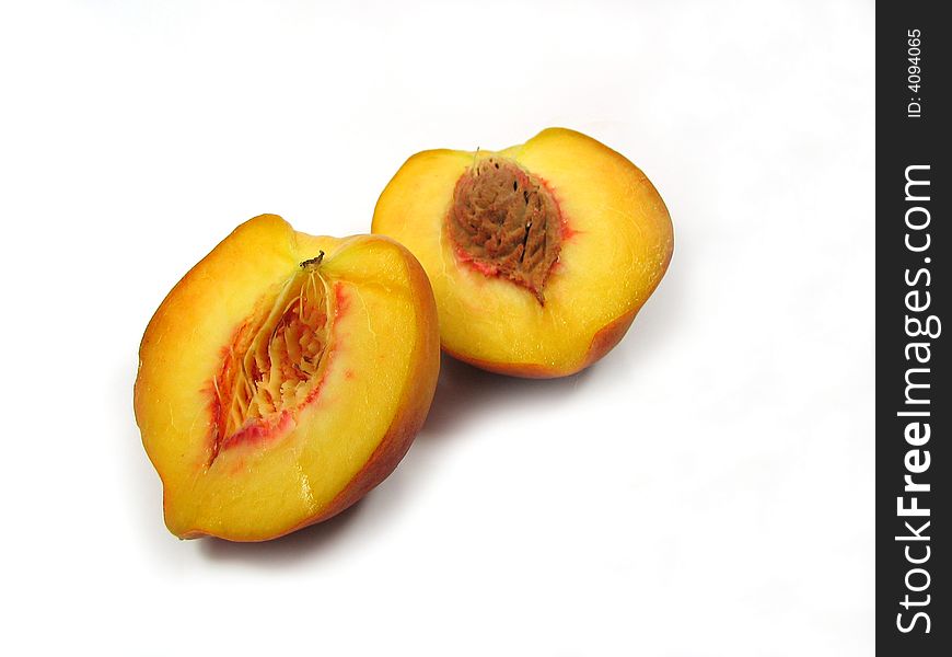 Peach cut in half with seed .