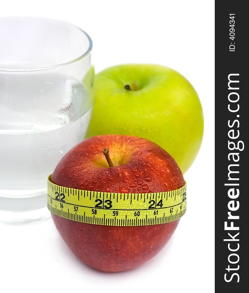 Glass with Water, Green and Red Apple with measuring tape