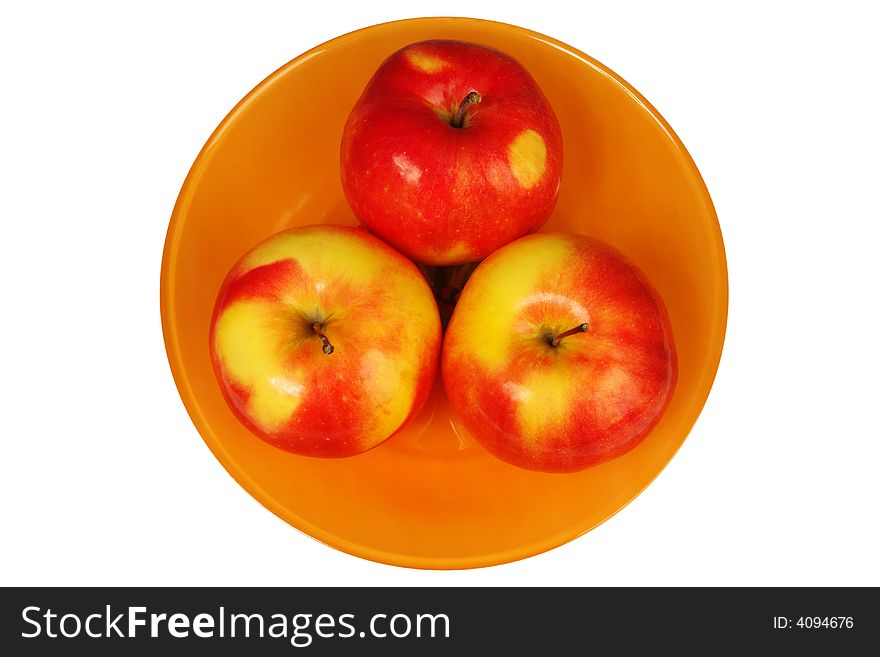 Three fresh apples in a plate on a white background
